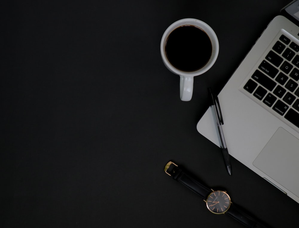 A clean, minimalist workspace with a laptop and a cup of coffee, symbolizing professional communication.