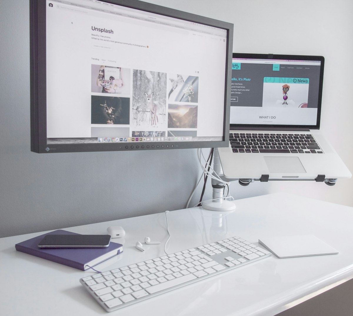 A clean, modern workspace with a laptop displaying a minimalist website design.