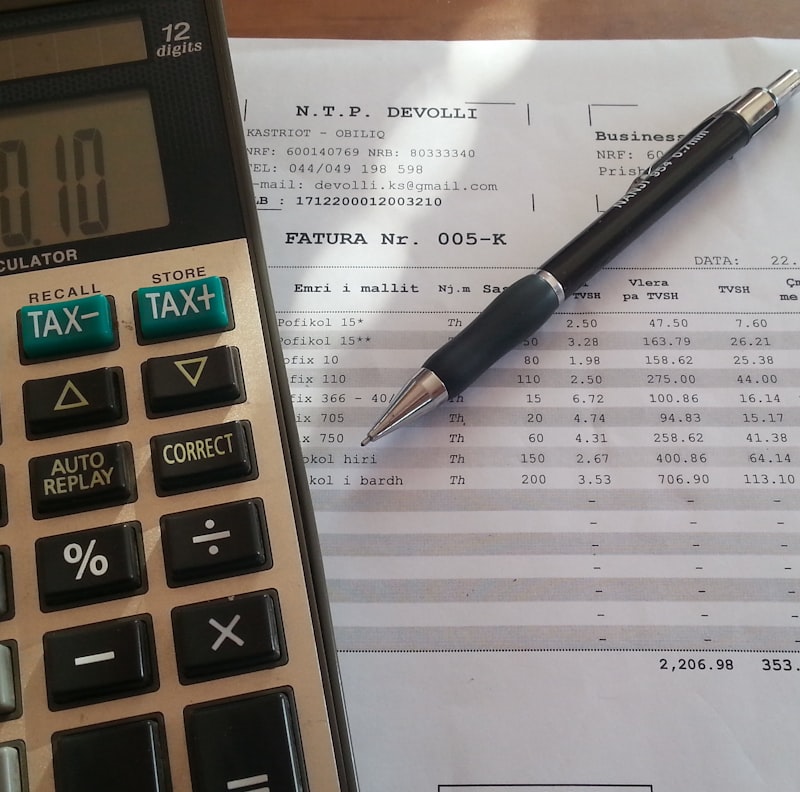 Close-up of hands reviewing financial documents on a modern desk.