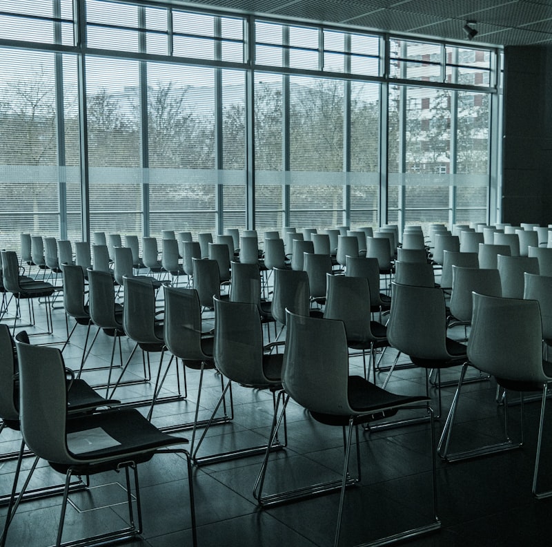 A calm meeting room with a large window overlooking a city skyline.