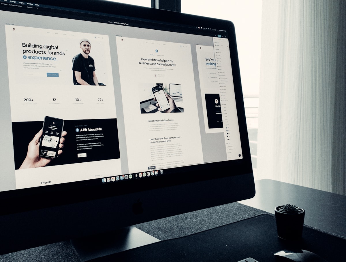 A sleek, modern workspace with a laptop displaying a minimalist website design.